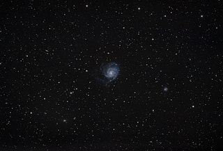 A spiral galaxy in the center of the frame