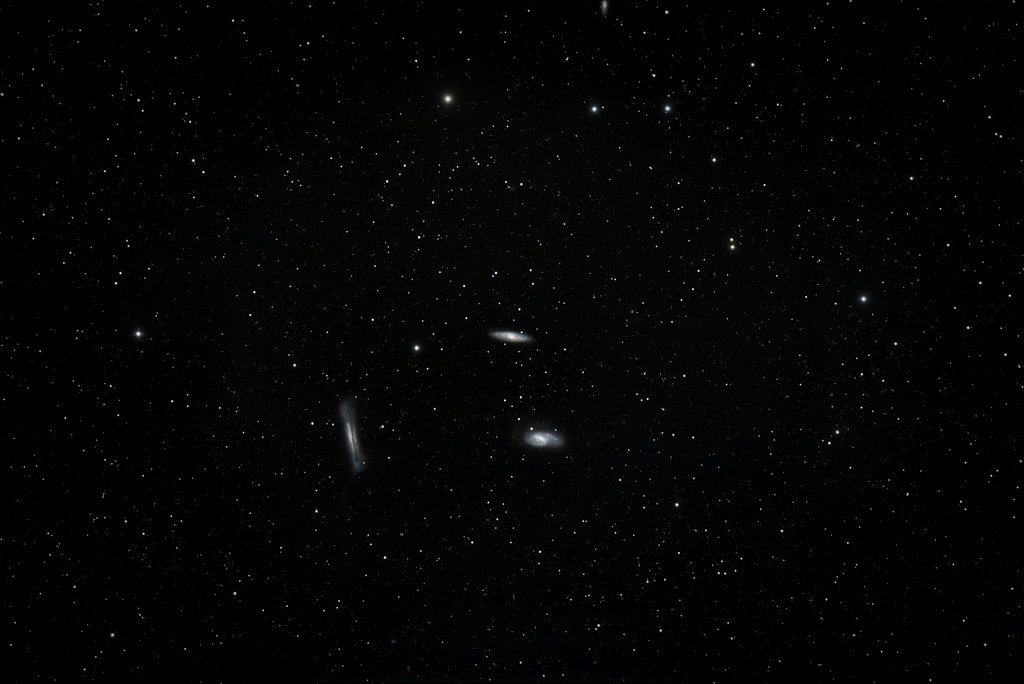 Three galaxies, small in the middle of the frame, one side-on, one at about 30 degrees, and the third from almost 90 degrees above.