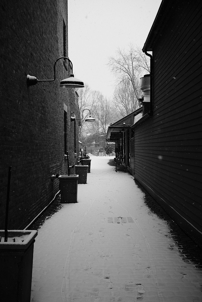 A lightly snowy alley