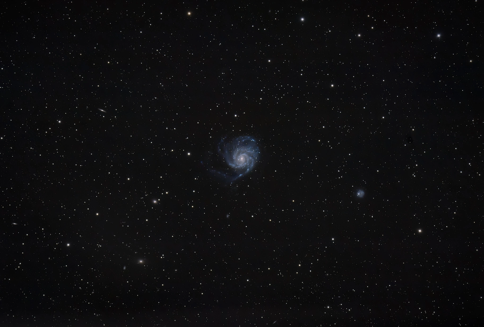 A spiral galaxy in the center of the frame
